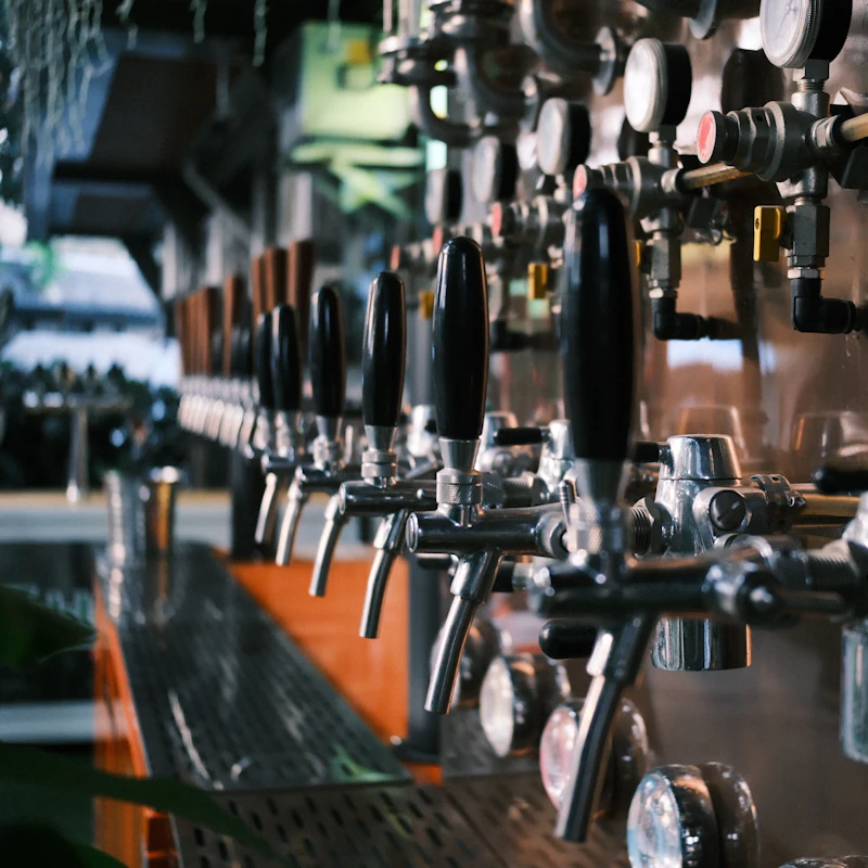 A row of beer taps at the bar